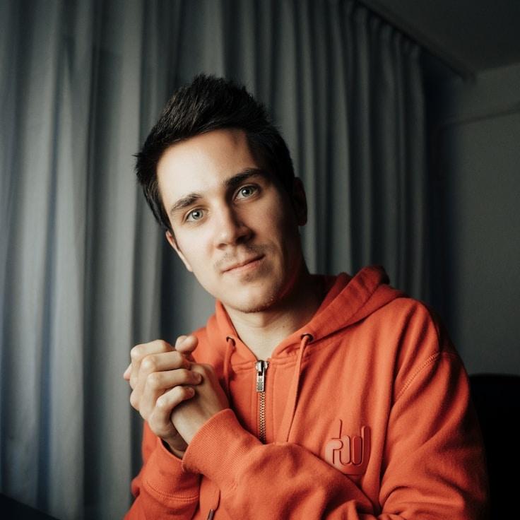 Alex Kim, Lead Design Curator at Clear Practice Journey, reviewing corporate floral arrangements